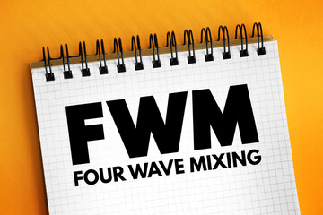 FWM - Four-Wave Mixing acronym text on notepad, abbreviation concept background