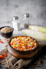 Corn red bell pepper black and white and brown rice in a bowl