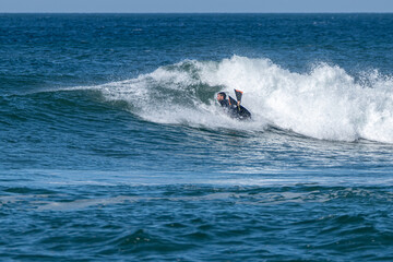 Bodyboarder surfing ocean wave