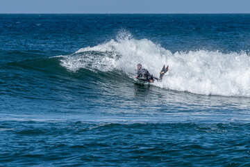 Bodyboarder surfing ocean wave
