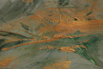 Art oil and acrylic smear blot canvas painting wall. Abstract green, gold color stain brushstroke texture background.