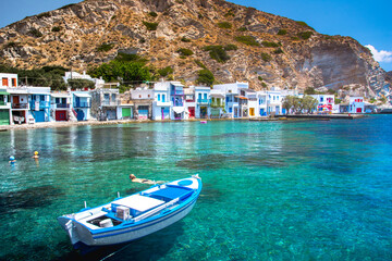 Fototapeta na wymiar Scenic Klima village (traditional Greek village by the sea, the Cycladic-style) with sirmata - traditional fishermen's houses, Milos island, Cyclades, Greece.