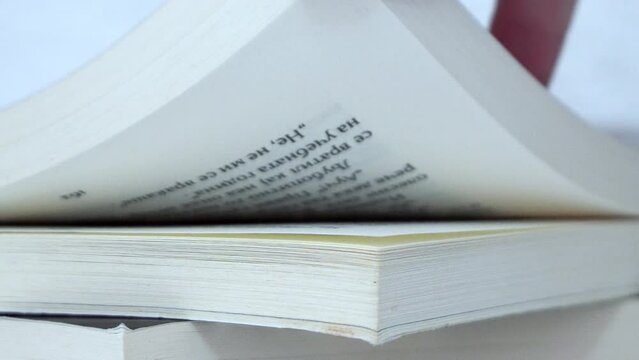Hand turning page of book