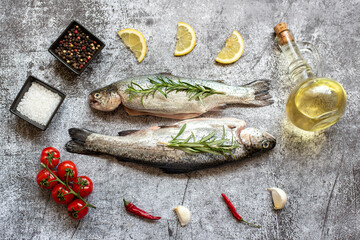 raw trout with spices on stone background