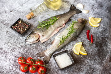 raw trout with spices on stone background
