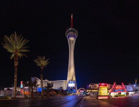 Las Vegas, United States - November 22, 2022: A picture of the STRAT Hotel, Casino and SkyPod, the Las Vegas Boulevard Gateway Arches, and the Chapel of the Bells at night.