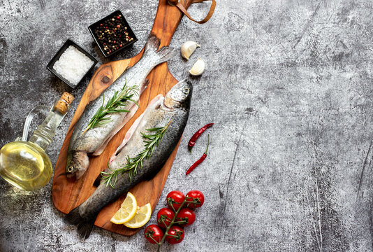 raw trout with spices on stone background with copy space for your text