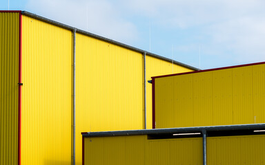 Facades of yellow warehouse with blue sky