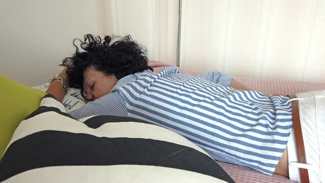 Young unconscious woman with pills lying on bed. Suicide concept