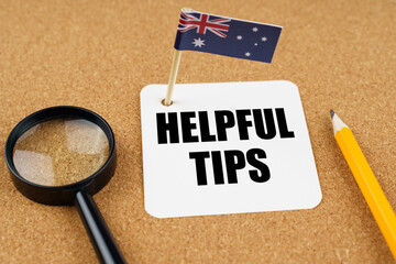 On the table is the flag of Australia, a pencil and a piece of paper with the inscription - Helpful Tips