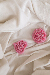 Pink wax candle in the form of small flowers