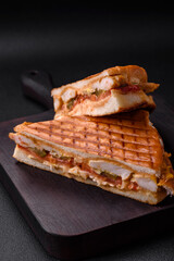 Delicious crispy sandwich with chicken breast, tomatoes, ketchup and spices