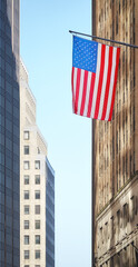 American flag with buildings in the background, selective focus, New York City, USA.