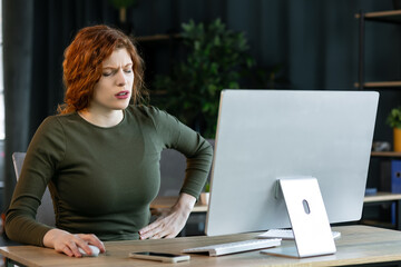 Business woman with stomach ache in office