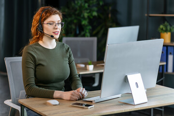 Female customer support operator with headset and smiling.