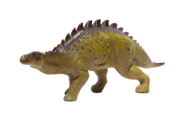 Close up of a plastic dinosaur toy with spikes on its back isolated on white background.