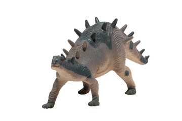 Worn out kentrosaurus toy isolated on white background. Dinosaur.