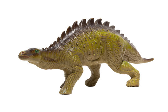 Fototapeta Close up of a plastic dinosaur toy with spikes on its back isolated on white background.