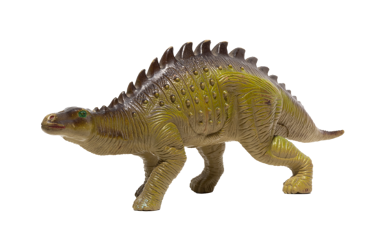 Close up of a plastic dinosaur toy with spikes on its back isolated on white background.