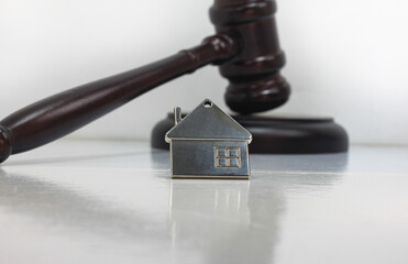 Abstract photo with wooden gavel and abstract house
