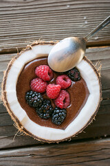 chocolate mousse in a coconut with berries 