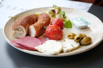 salami sausage , olive and bread on a plate 