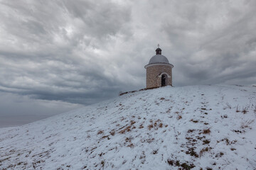 Winter landscape with snow. Landscape with a vineyard in Moravia in the Czech Republic with a chapel Hradistek.