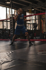 Obraz premium A boxer in the gym who fights with the shadow practices punches