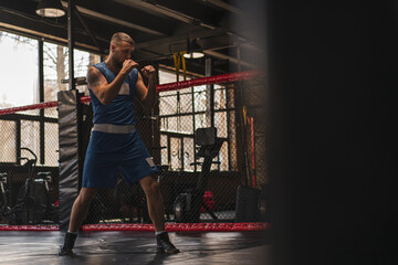 A boxer in the gym who fights with the shadow practices punches