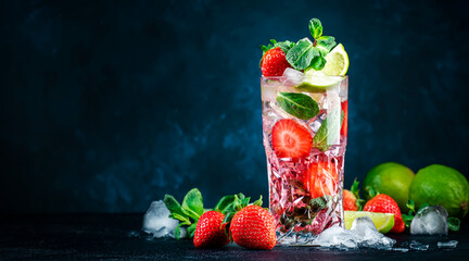 Strawberry Mojito cocktail drink with lime, white rum, soda, cane sugar, mint, and ice in glass on deep blue background. Summer refreshing beverage - Powered by Adobe