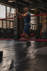 Obraz premium A boxer in the gym who fights with the shadow practices punches