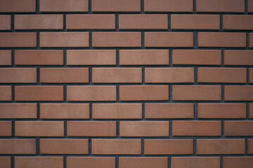 The wall is tiled under brick.