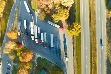 Aerial view of big rest area near busy american freeway with fast moving cars and trucks....