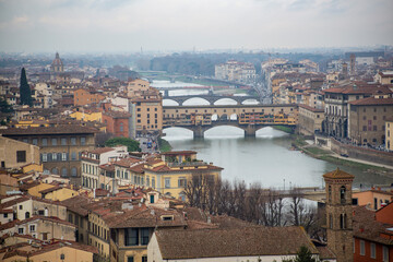Fototapeta na wymiar View from the top of the city of Florence including the Ponte Vecchio on the Arno river in the middle of the city, Italy