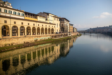 Fototapeta na wymiar Bank of the Arno river in Florence with a view of the Uffizi museum, in Italy