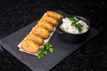 Bolinhos de bacalhau, very famous in Portuguese gastronomy. Fried dumpling, cod dumpling, fish,...