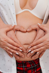 a man's hand on the stomach of a pregnant woman. 