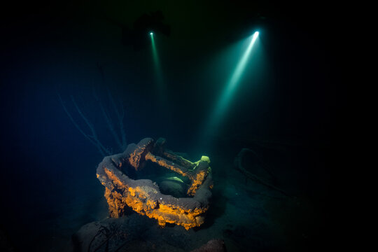 Taucher beleuchten eine alte Bergbau-Lore in einem mit Wasser gef&uuml;llten Steinbruch