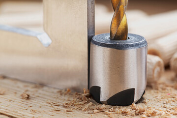 Countersink drill bit with steel triangle ruler make sink in hole for screw in wooden oak plank