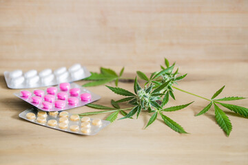 Medical marijuana cannabis with colorful pills on table. Cannabinoids or THC CBD for treatment.