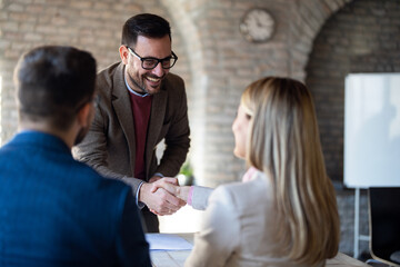 Business people handshaking at meeting in office