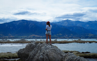 Kaikōura, Canterbury, New Zealand.


Young Lady stands on rocks overlooking 'Gooch Bay' in...