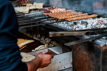 Traditional kebap is grilling on barbeque, close up, details