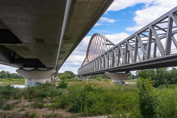 Obraz premium Lutherstadt Wittenberg, Germany-07-22-2022: Two Elbe bridges in Lutherstadt Wittenberg next to each other