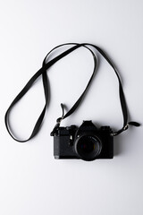 Close up of black camera with laces on white background with copy space