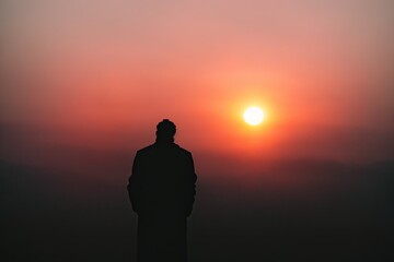 Muslim praying in a mystical environment, silhouette photo, no face visible, generative ai, color grading, islam religion concept photo