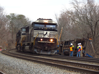 Fototapeta na wymiar Ayer, Massachusetts/USA - 3/23/2023 - Norfolk Southern locomotives work to put together the rest of train #265 after at least 5 well cars carrying trash and recyclables derailed this morning.