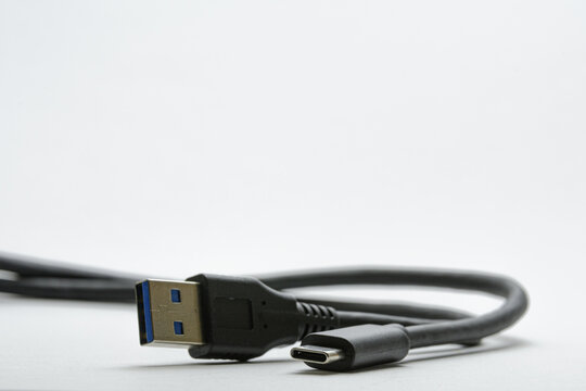 Cable with USB Type A and USB Type C plugs, on a white background, black cable with a blue plug on a white background.