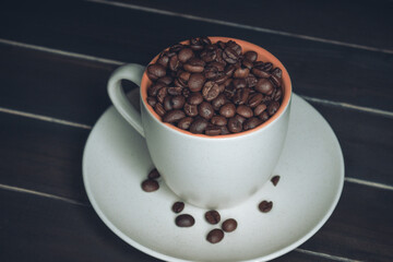 Cup full of coffee beans