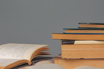 Open Books with a stack of closed books in the background